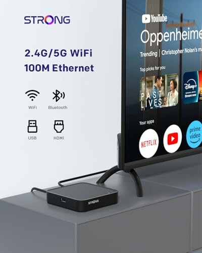 Streaming-Gerät neben einem Fernseher mit App-Icons.